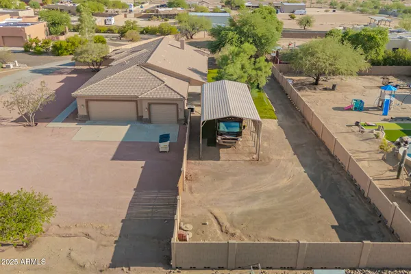 an aerial view of residential houses with outdoor space and trees