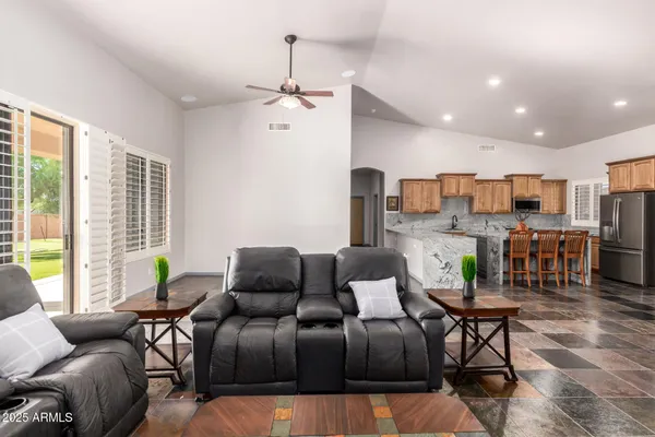 a view of a livingroom with furniture and a flat screen tv