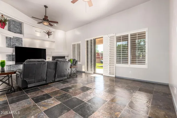 a living room with furniture a flat screen tv and a fireplace