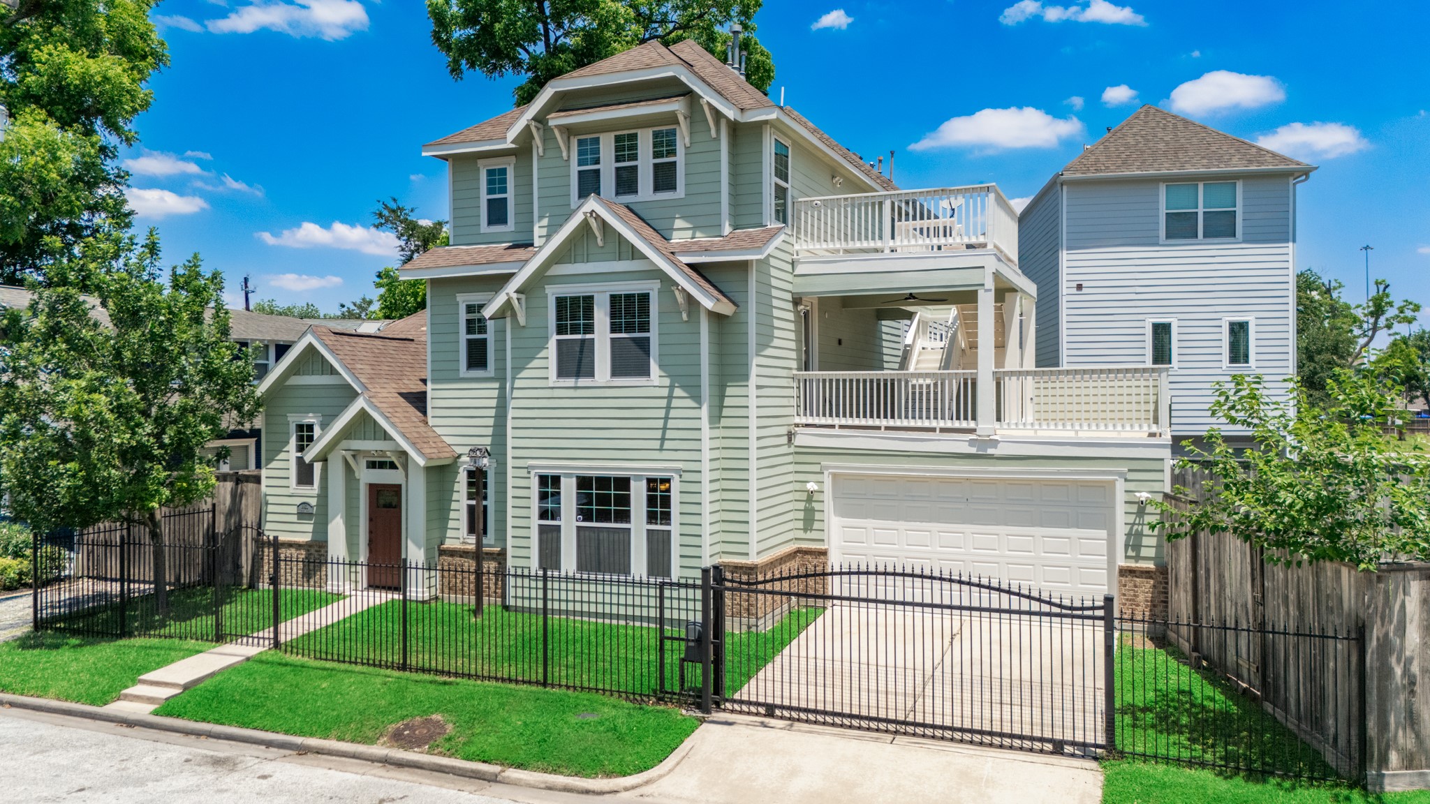 6621 North Main Street Houston, TX 77009 - Photo 1 of 41 This charming multi-story home features a light green facade with white trim, a spacious balcony, and a secure gated driveway. The lush front lawn and mature trees enhance its curb appeal.