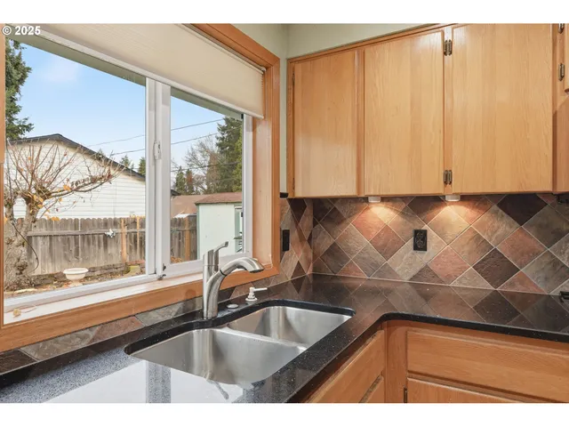 a kitchen with a sink and large window