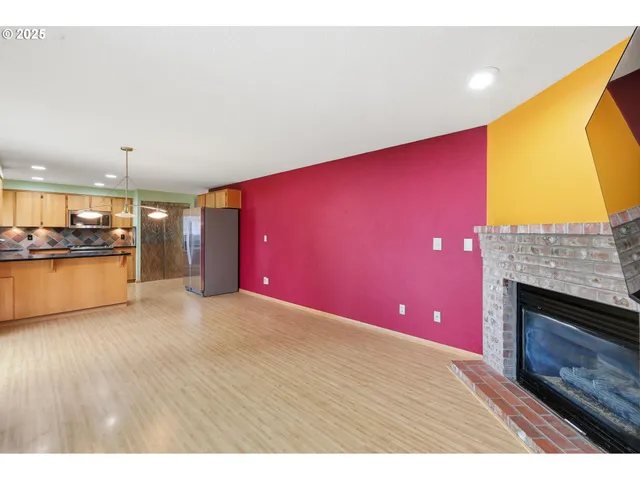 a view of an empty room with a fireplace