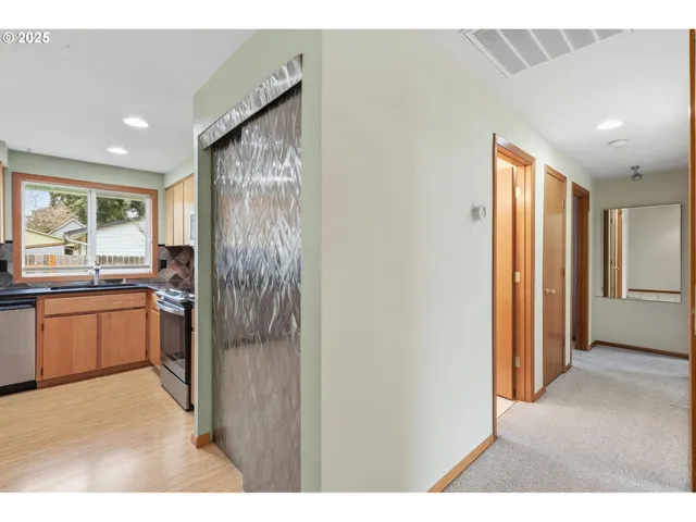 a kitchen with a refrigerator and a sink