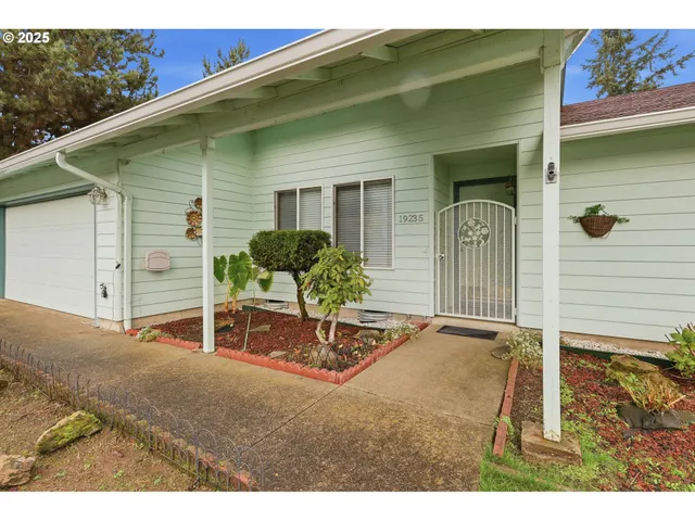a backyard of a house with table and chairs