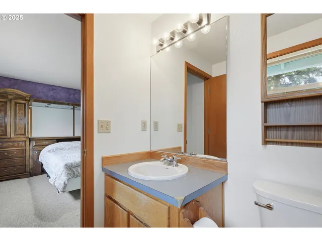 a bathroom with a sink vanity and a mirror