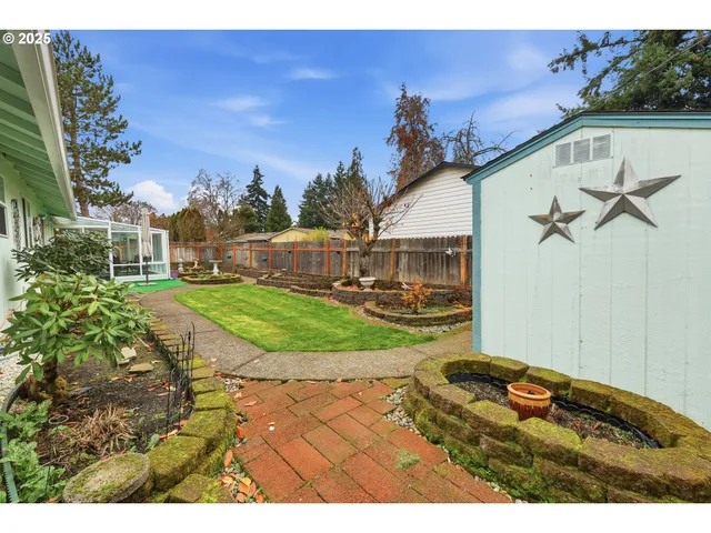 a view of a house with backyard sitting area and garden
