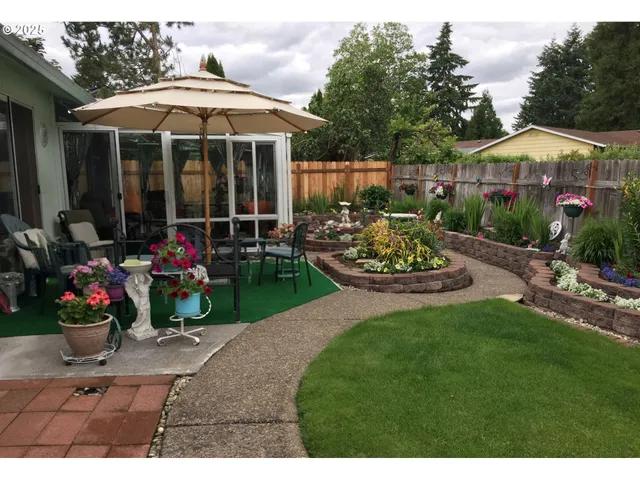 a view of a backyard with plants and a garden