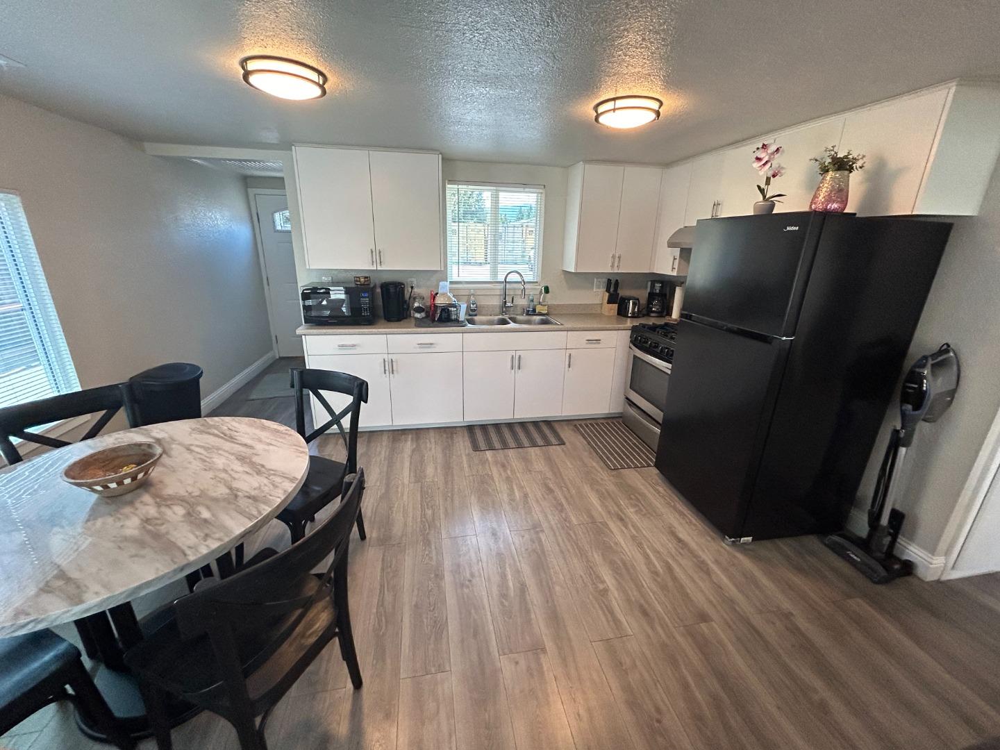 756 1st Street Gilroy, CA 95020 - Photo 7 of 14 a kitchen with a table chairs refrigerator and window