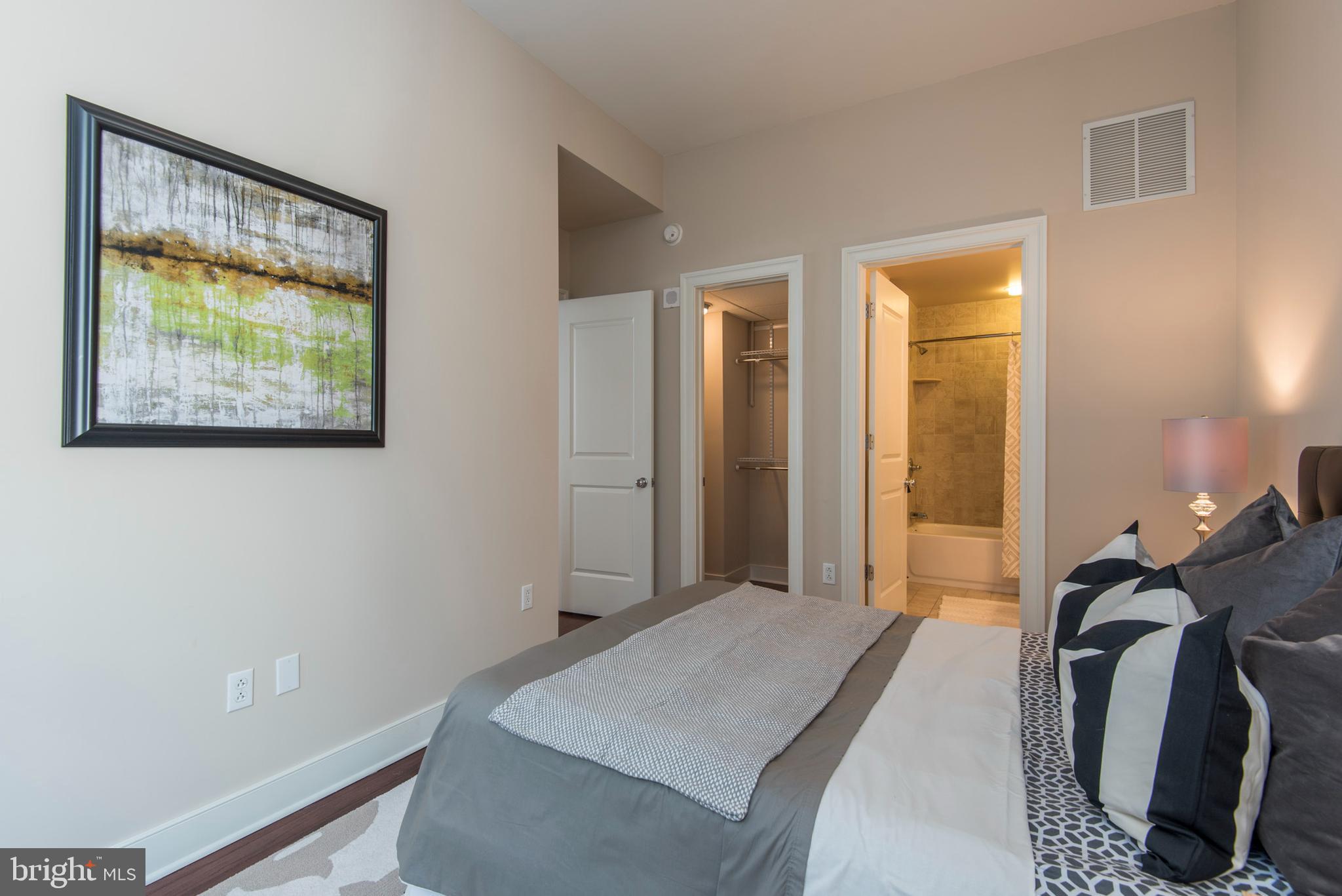 1501 Locust Street, Unit 403 Philadelphia, PA 19102 - Photo 17 of 23 a bed room with a bed and a painting