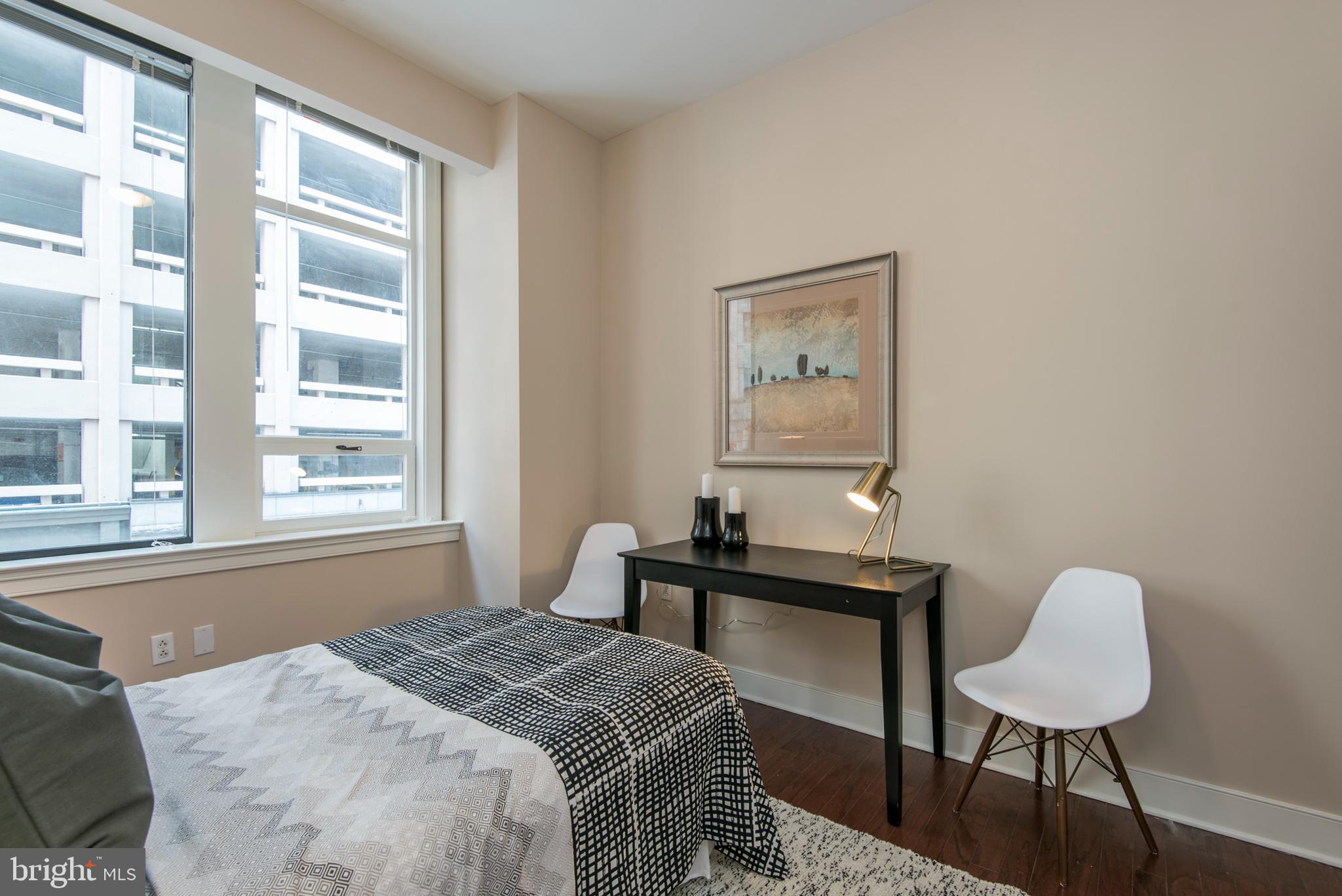 1501 Locust Street, Unit 403 Philadelphia, PA 19102 - Photo 20 of 23 a bedroom with a bed and a table with chair
