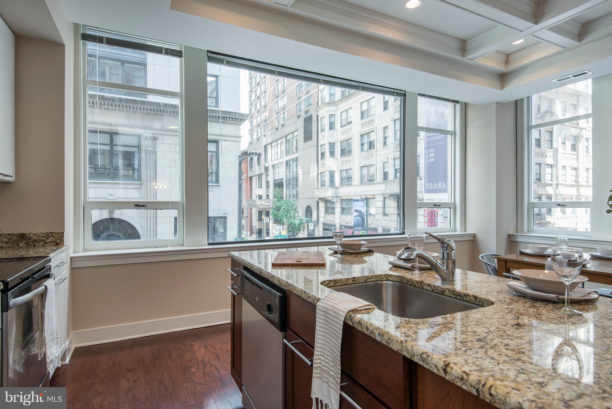 1501 Locust Street, Unit 403 Philadelphia, PA 19102 - Photo 2 of 23 a kitchen with granite countertop a sink and a stove top oven