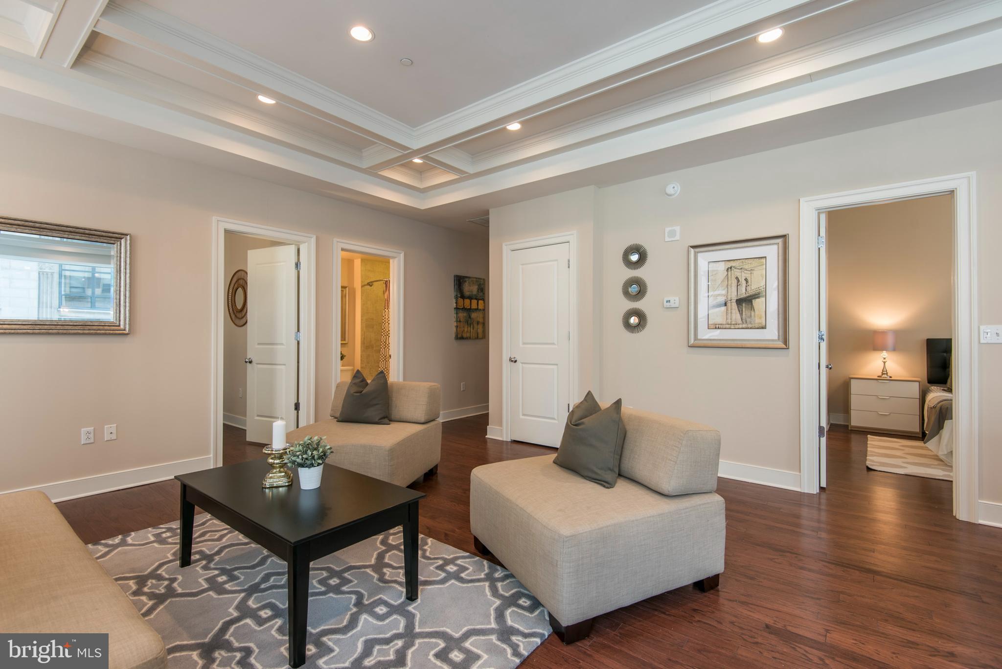 1501 Locust Street, Unit 403 Philadelphia, PA 19102 - Photo 5 of 23 a living room with furniture and wooden floor