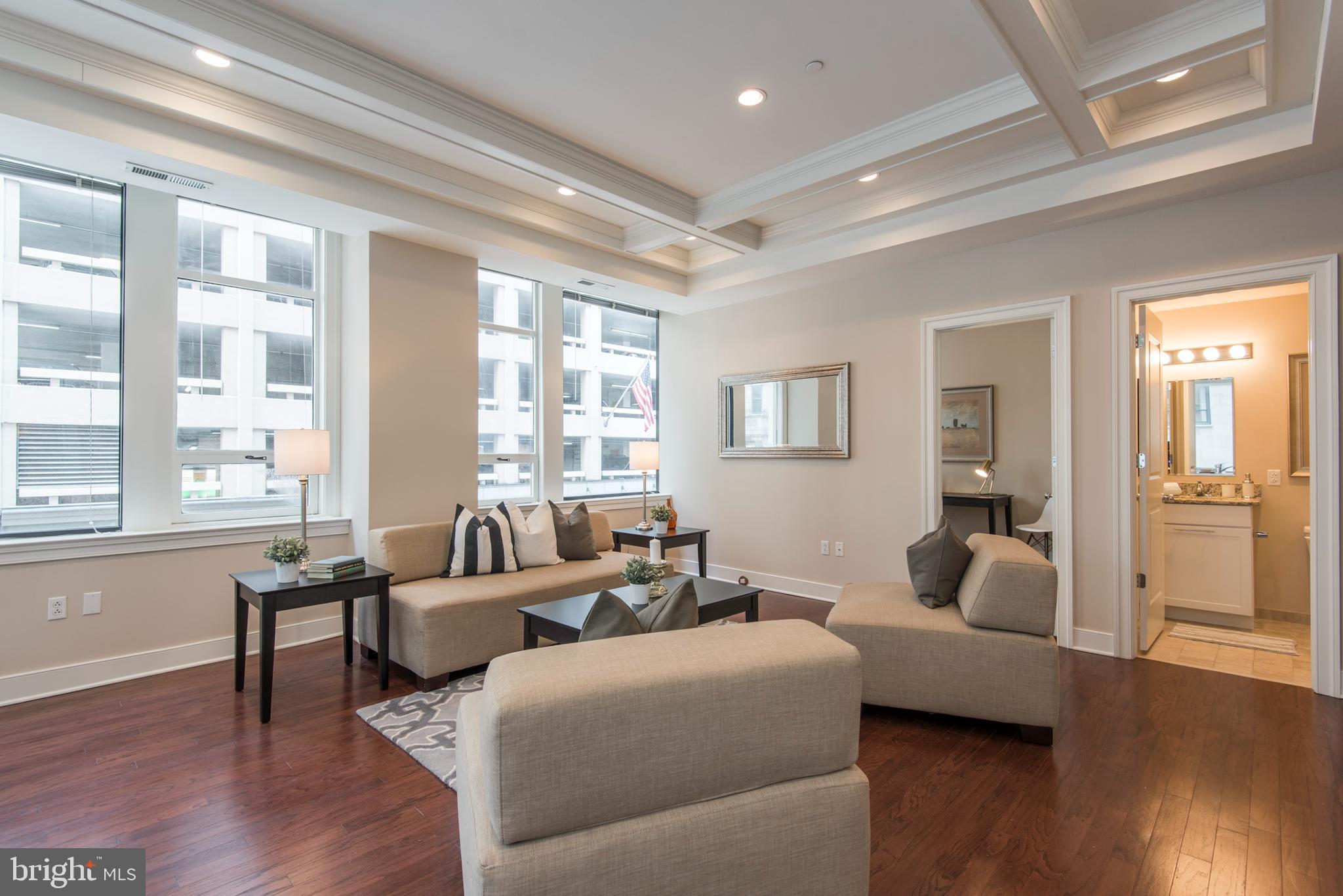 1501 Locust Street, Unit 403 Philadelphia, PA 19102 - Photo 6 of 23 a living room with furniture and a wooden floor