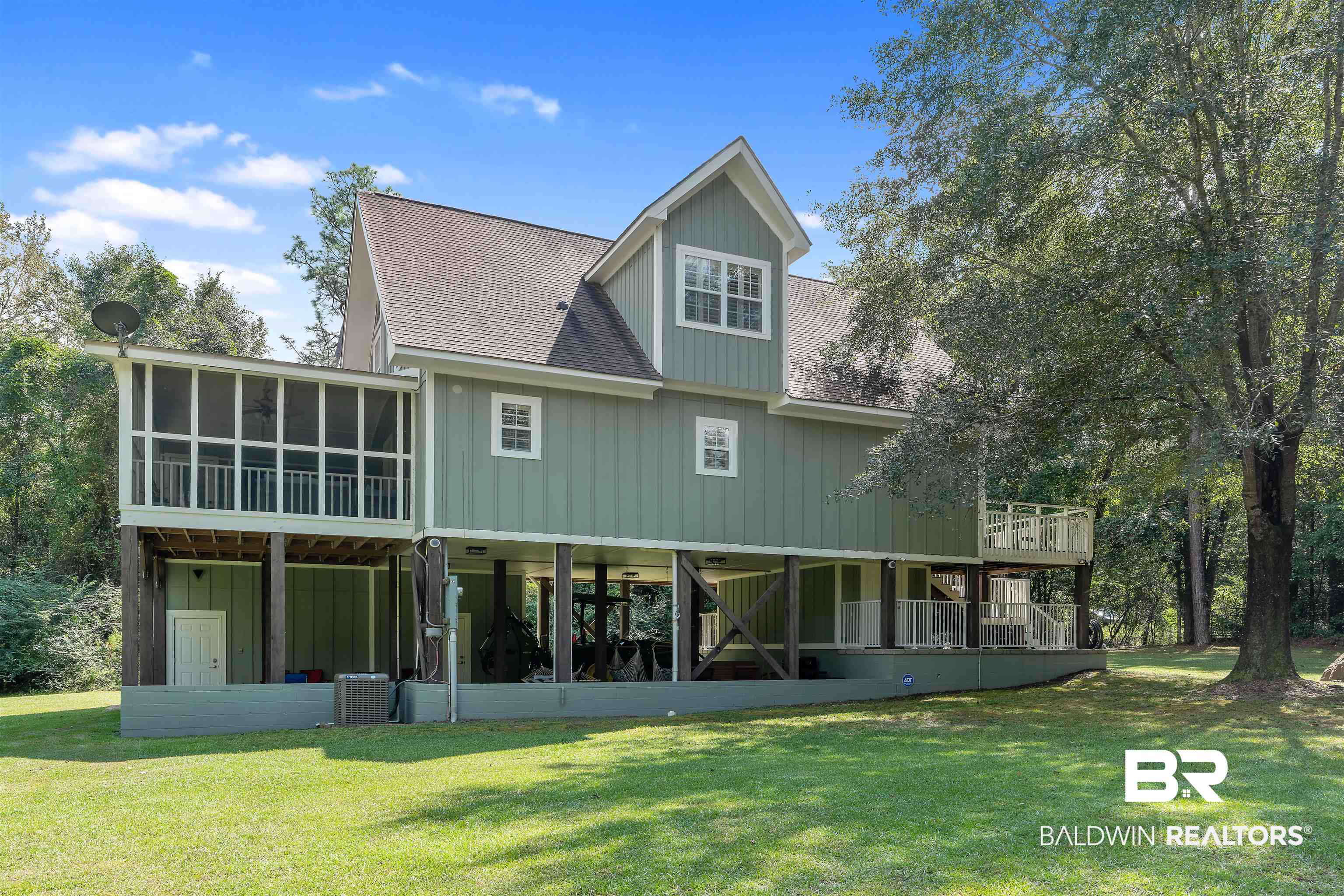 25591 Waterworld Road Robertsdale, AL 36567 - Photo 1 of 33 Back of house with a sunroom and a lawn