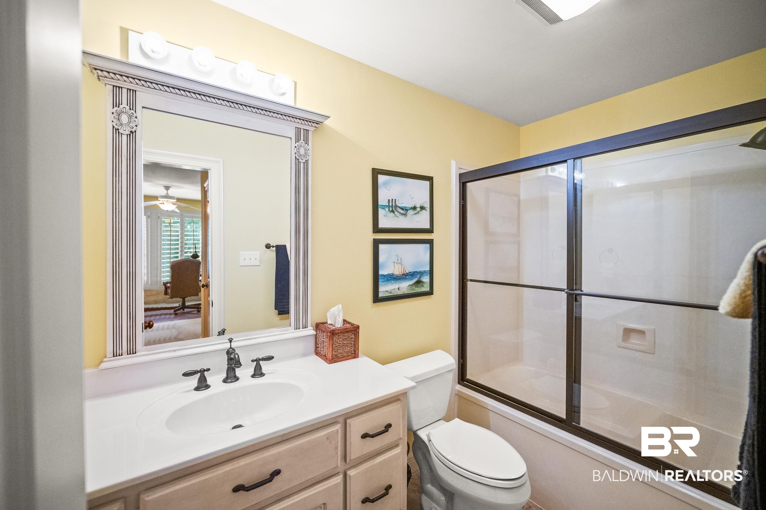 404 Peninsula Boulevard Gulf Shores, AL 36542 - Photo 27 of 51 Bathroom with bath / shower combo with glass door, vanity, and connected bathroom