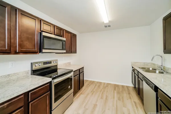 a kitchen with a stove microwave and sink