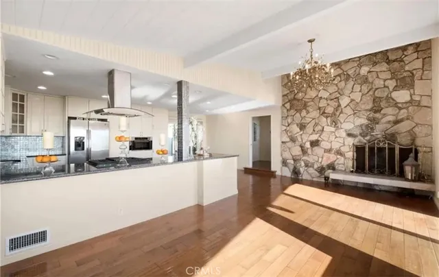 a large white kitchen with stainless steel appliances