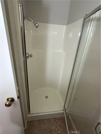 a bathroom with a glass door shower