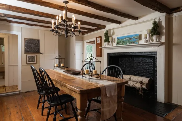 a view of a dining room with furniture and chandelier