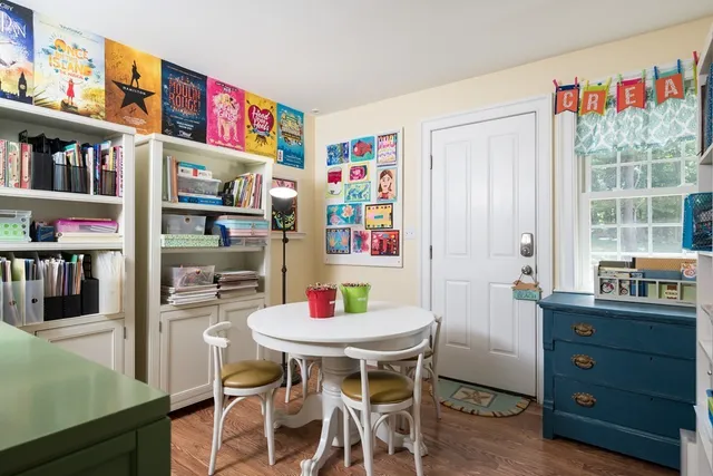 a view of a dining room with furniture and a kitchen