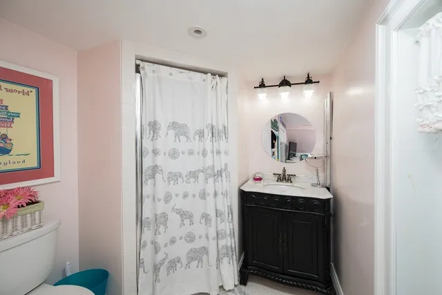 a bathroom with a sink toilet and shower