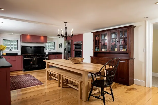 a dining room with a table chairs and kitchen view