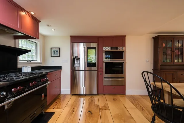 a kitchen with granite countertop a stove and a refrigerator