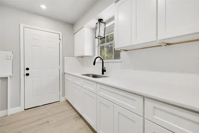 a kitchen with a sink and cabinets