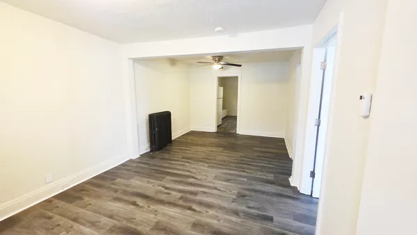 a view of a room with wooden floor