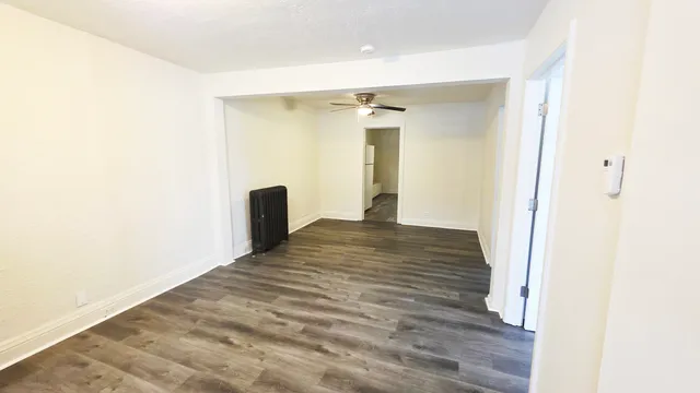 a view of a room with wooden floor