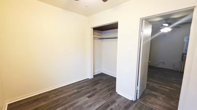 a view of a hallway with wooden floor