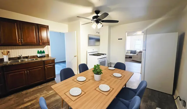 a view of a dining room with furniture a chandelier and wooden floor