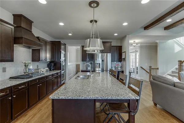 a kitchen with center island a sink appliances and cabinets