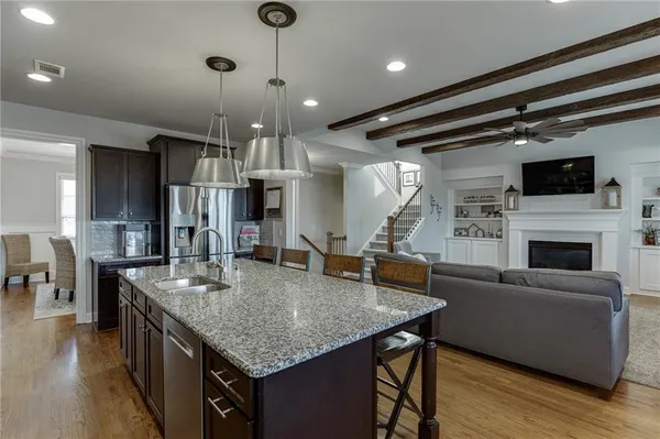 a kitchen with center island a table and chairs