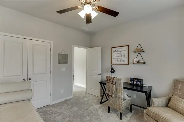 a bed room with a bed and a ceiling fan