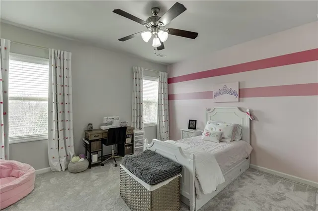 a spacious bedroom with a bed and a chandelier