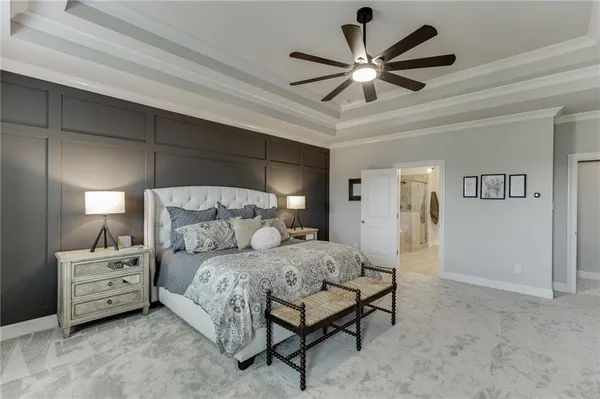 a spacious bathroom with a granite countertop sink a mirror and a bathtub