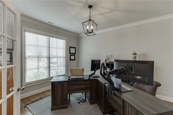 a view of a workspace with furniture and a window