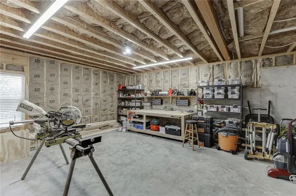 an aerial view of residential houses with outdoor space and parking