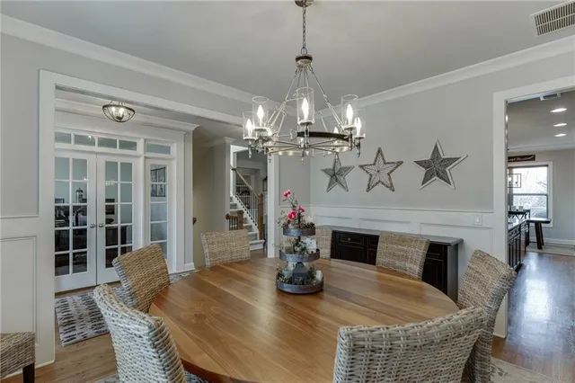 a view of a dining room with furniture wooden floor and chandelier