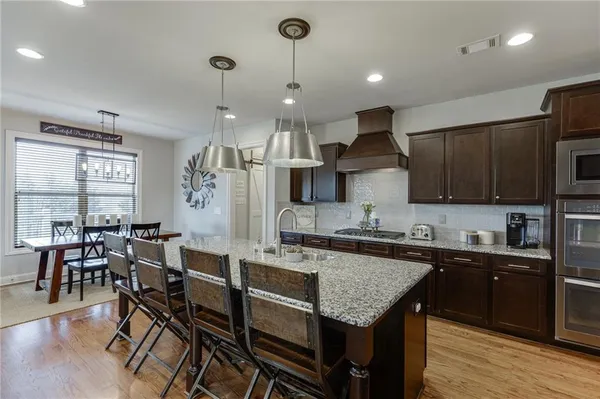 a kitchen with lots of counter space a sink appliances and cabinets