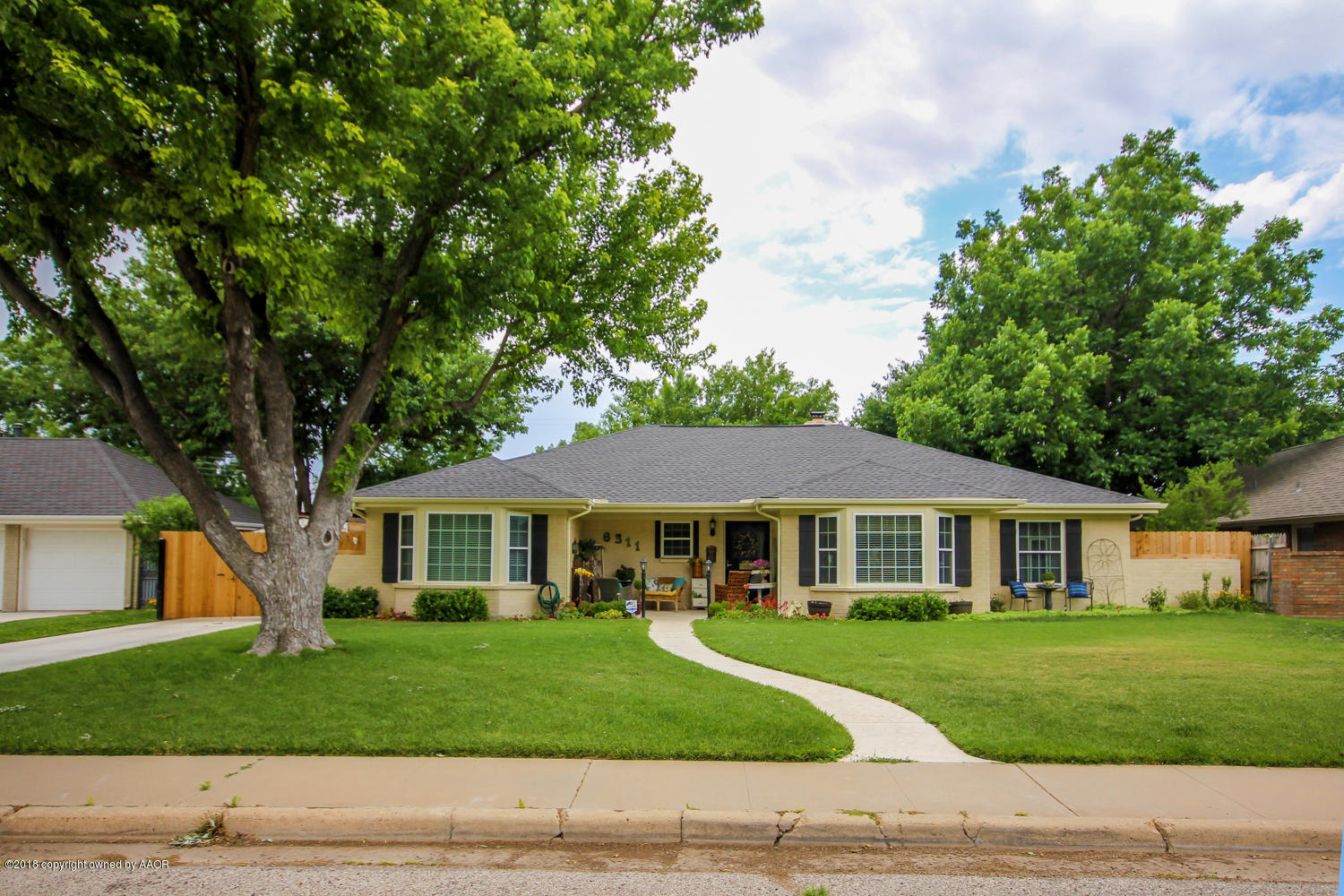 6311 Elmhurst Road Amarillo, TX 79106 - Photo 1 of 38 a front view of a house with a garden