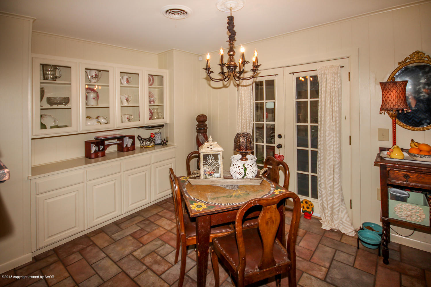 6311 Elmhurst Road Amarillo, TX 79106 - Photo 14 of 38 a view of a dining room with furniture a chandelier and wooden floor