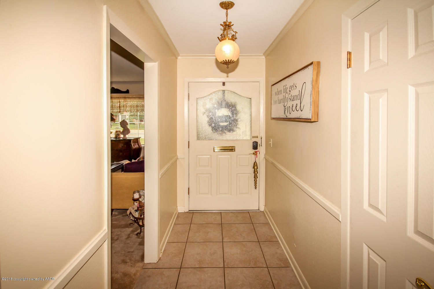 6311 Elmhurst Road Amarillo, TX 79106 - Photo 3 of 38 a view of a hallway with a dining table and chandelier