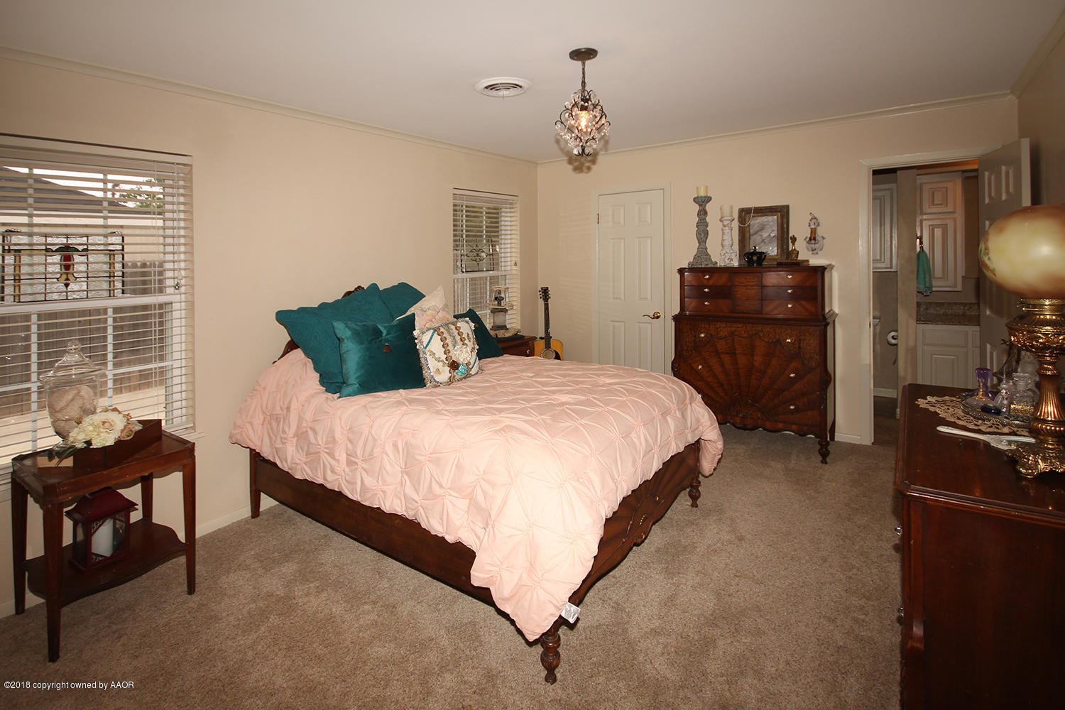 6311 Elmhurst Road Amarillo, TX 79106 - Photo 22 of 38 a bed room with a bed window and a chair