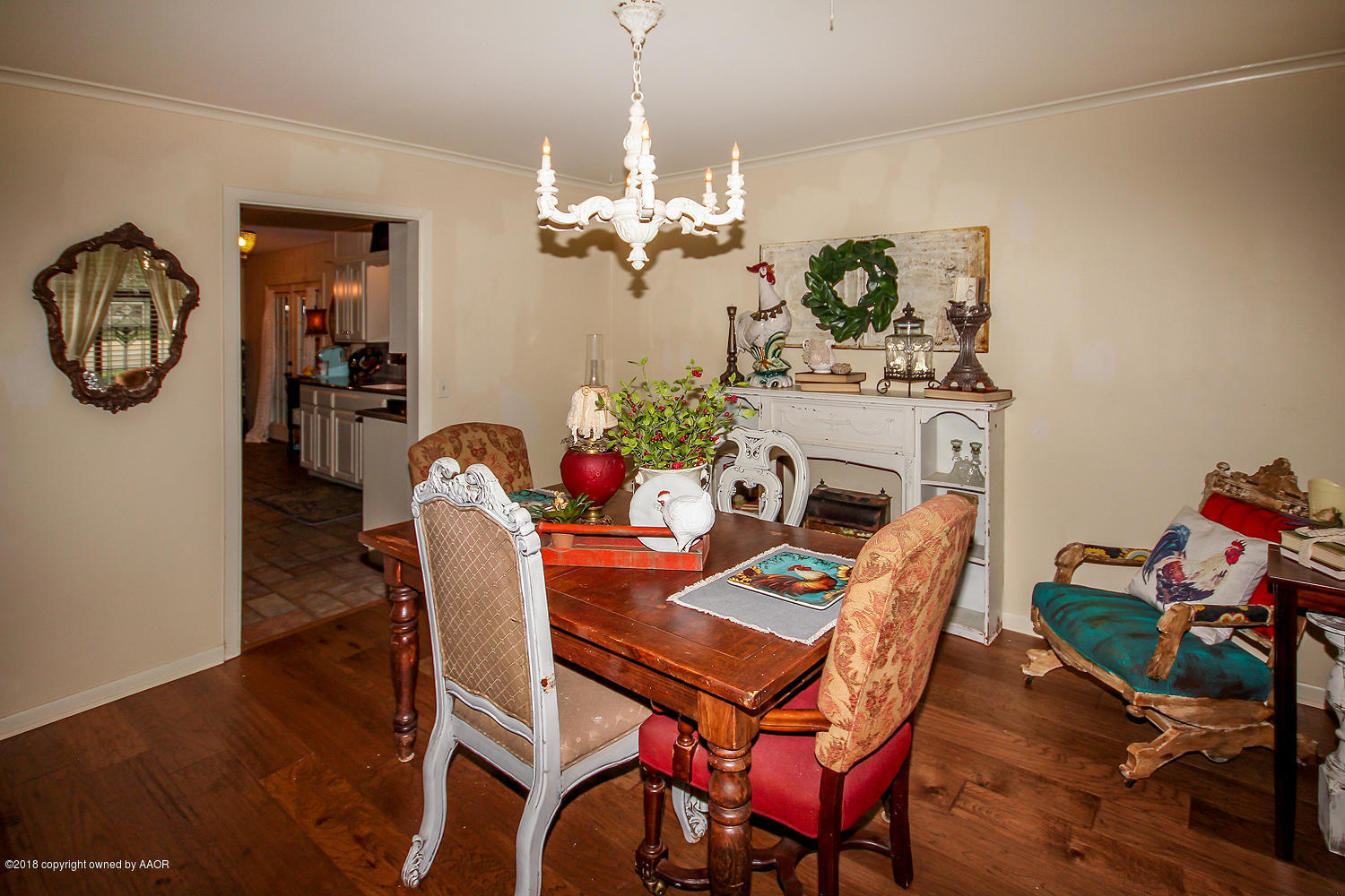 6311 Elmhurst Road Amarillo, TX 79106 - Photo 7 of 38 a dining room with furniture a chandelier and wooden floor