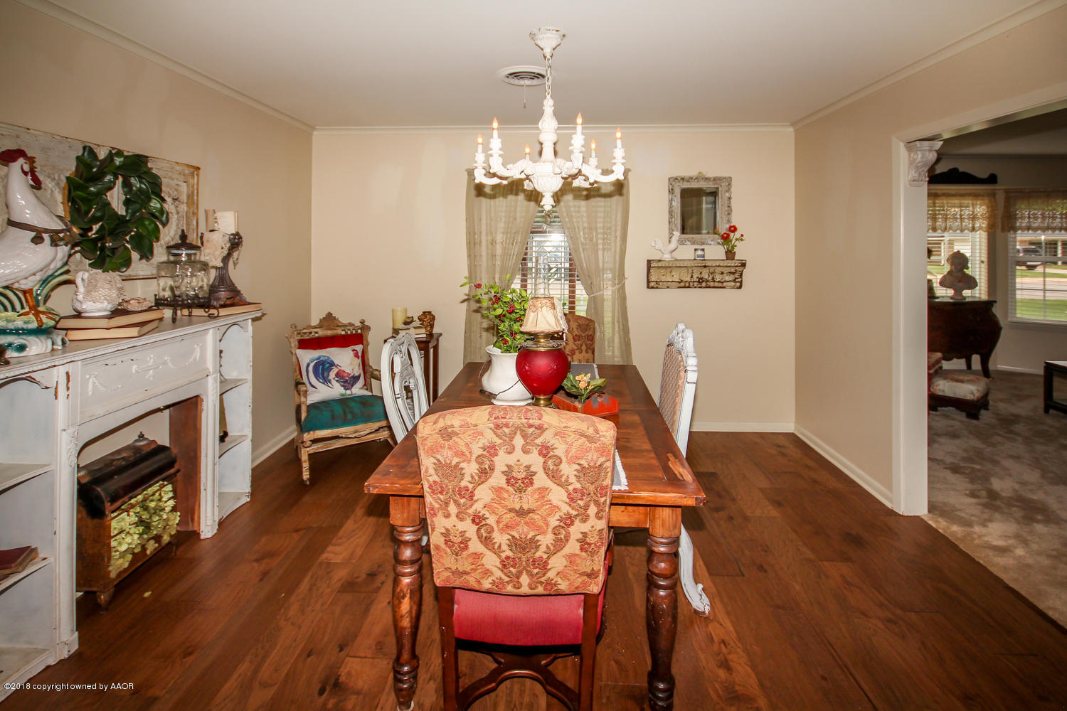 6311 Elmhurst Road Amarillo, TX 79106 - Photo 8 of 38 a dining room with furniture a chandelier and wooden floor