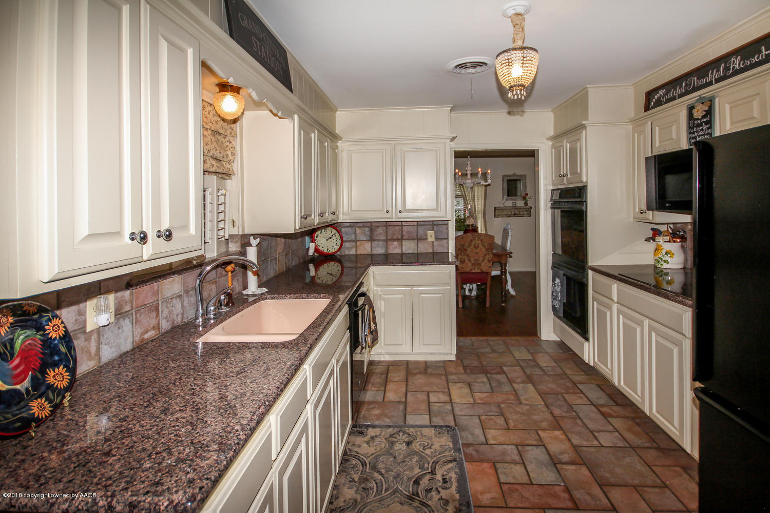 6311 Elmhurst Road Amarillo, TX 79106 - Photo 10 of 38 a large kitchen with stainless steel appliances granite countertop a sink and cabinets