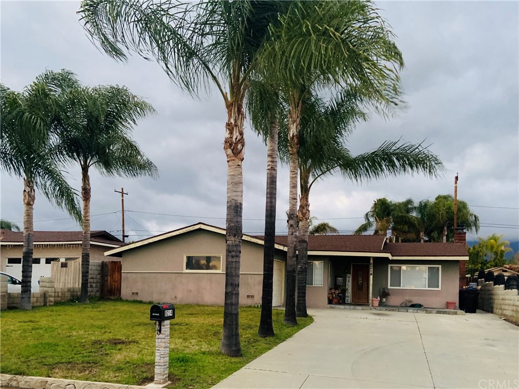 8214 Arrow Route Rancho Cucamonga, CA 91730 - Photo 1 of 1 a front view of a house with a garden and palm trees