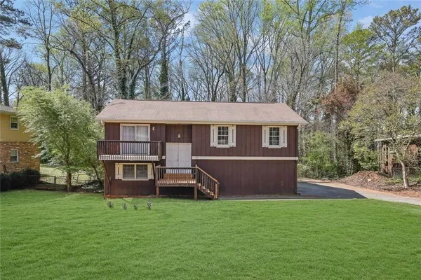 a front view of a house with a garden